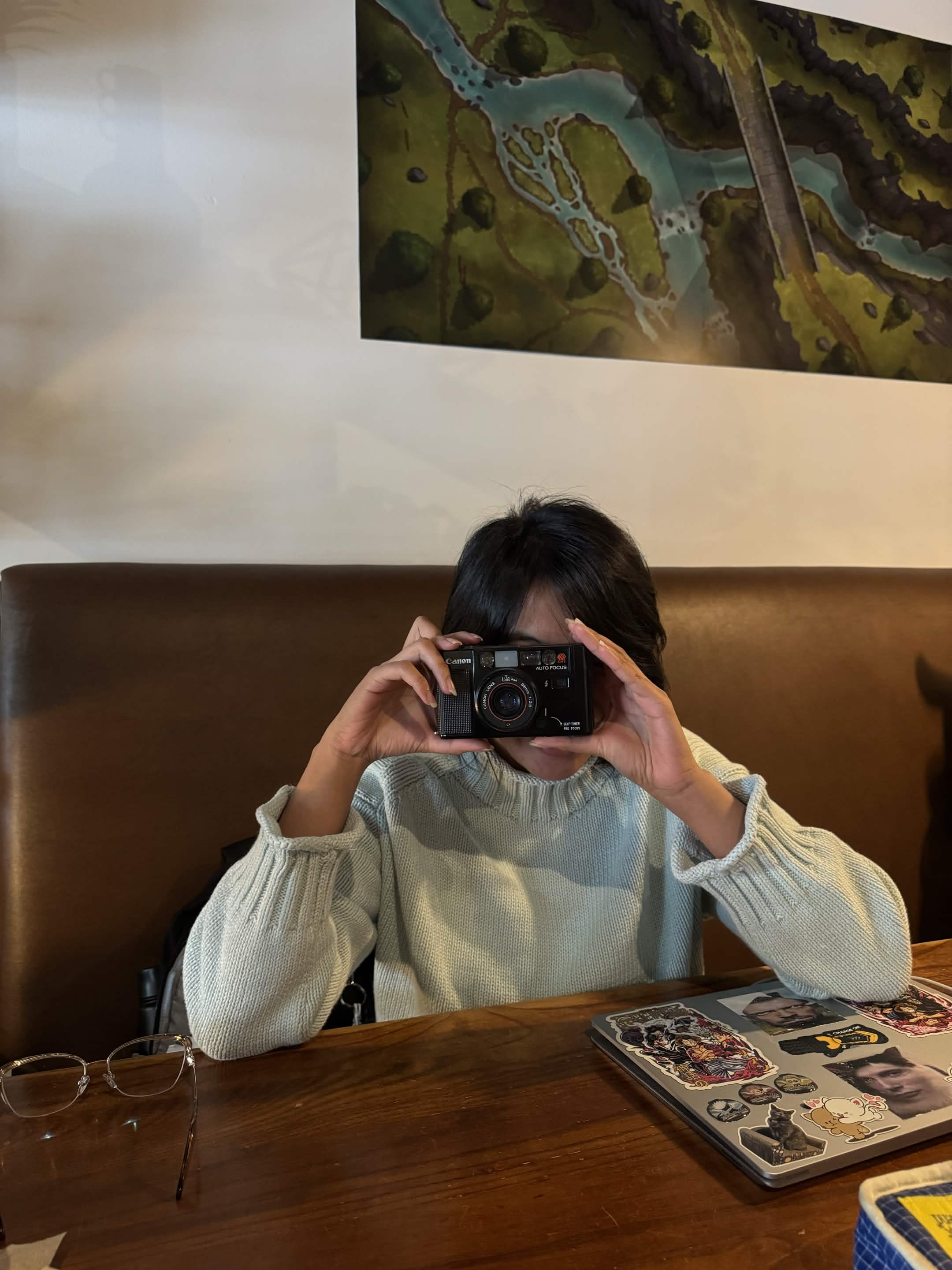 Holding a film camera up to take a photo